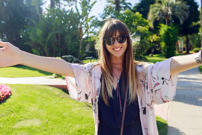 Person smiling with perfect teeth, showcasing the Hollywood smile.