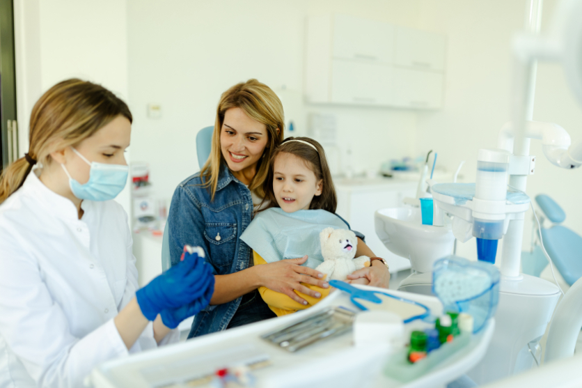 Mother and daughter listening to the Buford dentist.